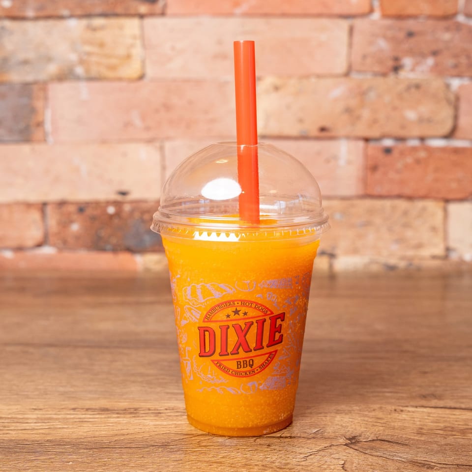 A Dixie BBQ branded cup filled with a bright orange frozen drink and an orange straw.